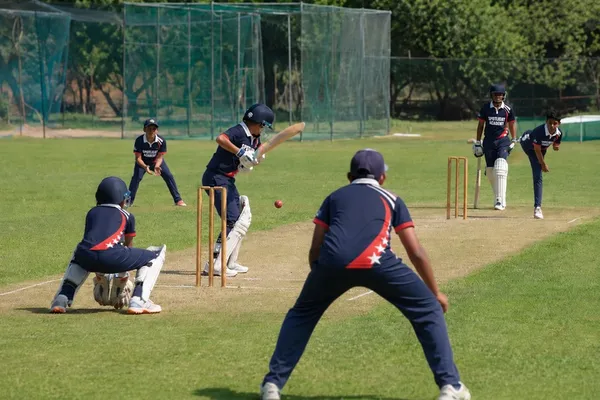 Spotlight Academy cricket students playing a full outdoor match with batter, wicket keeper and fielders, The Woodlands TX